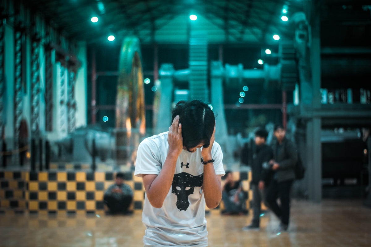 Man blocking ears from loud noise