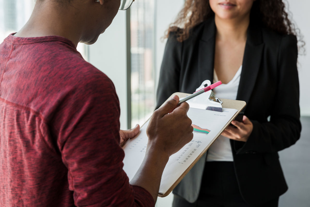 Man Holding Clipboard in Office